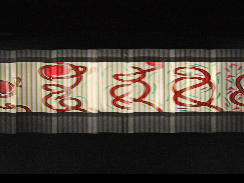 The Masstransiscope seen from a moving subway car, its red looping figures blurring into motion behind vertical slats